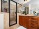 Elegant bathroom boasting a glass-enclosed shower and granite countertops with ample storage space in the wooden cabinets at 3581 Boulder Ct, Wake Forest, NC 27587