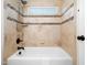 Bathroom with a tile shower-tub combination and decorative tile accents at 3581 Boulder Ct, Wake Forest, NC 27587