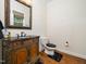 Elegant powder room with a carved wooden vanity and black marble countertop with a decorative mirror at 3581 Boulder Ct, Wake Forest, NC 27587