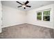Spacious bedroom with neutral carpet, a ceiling fan, and a window overlooking the backyard at 3581 Boulder Ct, Wake Forest, NC 27587