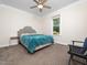 This bedroom features plush carpet, a ceiling fan, and a large window overlooking the backyard at 3581 Boulder Ct, Wake Forest, NC 27587