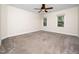 Large bedroom with neutral carpet, ample natural light from two windows, and a ceiling fan at 3581 Boulder Ct, Wake Forest, NC 27587