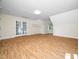 Bright bonus room with hardwood floors, neutral walls, and double doors to the outside at 3581 Boulder Ct, Wake Forest, NC 27587