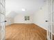 Expansive bonus room with hardwood floors, a dormer window, and french doors at 3581 Boulder Ct, Wake Forest, NC 27587