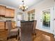 Bright dining area features a glass table, woven chairs, light fixture, and access to the screened in porch at 3581 Boulder Ct, Wake Forest, NC 27587