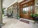 Charming covered front porch with stone accents and a beautifully crafted wood front door at 3581 Boulder Ct, Wake Forest, NC 27587