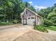 Detached two-car garage with basketball hoop and landscaping adjacent to a concrete driveway at 3581 Boulder Ct, Wake Forest, NC 27587