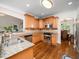 Well-lit kitchen with stainless steel appliances, granite countertops, and wooden cabinets at 3581 Boulder Ct, Wake Forest, NC 27587