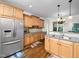 Gourmet kitchen featuring granite countertops, stainless steel refrigerator, and custom wood cabinets at 3581 Boulder Ct, Wake Forest, NC 27587