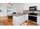 The kitchen features stainless steel appliances and a view into the sitting area at 3581 Boulder Ct, Wake Forest, NC 27587