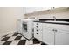 Efficient laundry room with modern washer and dryer, complemented by storage cabinets and a sleek sink at 3581 Boulder Ct, Wake Forest, NC 27587