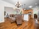 Elegant open-concept living space with hardwood floors, dining area and stairs to the second floor at 3581 Boulder Ct, Wake Forest, NC 27587