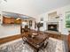 Open-concept living room with fireplace, adjoining kitchen and dining area at 3581 Boulder Ct, Wake Forest, NC 27587