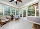 Inviting sunroom with lots of windows, a ceiling fan, tile floors, and access to the deck at 3581 Boulder Ct, Wake Forest, NC 27587