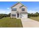 Charming two-story home with a well-manicured lawn and a one-car garage at 3641 Drafton Dr, Raleigh, NC 27610