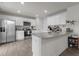 Bright kitchen with stainless steel appliances, granite countertops, and white cabinets at 3641 Drafton Dr, Raleigh, NC 27610