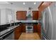 Well-lit kitchen with wooden cabinets, stainless steel appliances, and granite countertops at 400 W North St # 900, Raleigh, NC 27603