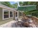 Outdoor back deck features seating and an umbrella for shade while enjoying the backyard at 4404 Oak Park Rd, Raleigh, NC 27612