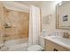 Cozy bathroom showcasing a shower-tub combination, complemented by neutral tiles and updated fixtures at 4404 Oak Park Rd, Raleigh, NC 27612