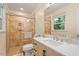 Bathroom featuring a glass shower and a vanity with a white countertop at 4404 Oak Park Rd, Raleigh, NC 27612