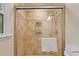 Shower with a glass door, tile surround and an adjustable shower head at 4404 Oak Park Rd, Raleigh, NC 27612