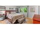 Bedroom with wood-look flooring, a queen bed with a patterned comforter and a window at 4404 Oak Park Rd, Raleigh, NC 27612