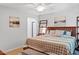 Bedroom with wood-look floors, a queen bed with a patterned comforter and a window at 4404 Oak Park Rd, Raleigh, NC 27612
