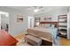 Bedroom with wood-look floors, a queen bed with a patterned comforter and a window at 4404 Oak Park Rd, Raleigh, NC 27612