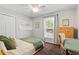 Cozy bedroom with a ceiling fan, neutral walls, and a window with natural light at 4404 Oak Park Rd, Raleigh, NC 27612