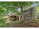 Exterior of a home showcases a large back deck and established yard with wooded perimeter at 4404 Oak Park Rd, Raleigh, NC 27612