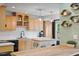 Charming kitchen features wood cabinets, modern appliances, an island, and unique wall decorations at 4404 Oak Park Rd, Raleigh, NC 27612