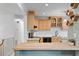 Well-lit kitchen showcases wood cabinets, modern appliances, and a stylish island with barstool seating at 4404 Oak Park Rd, Raleigh, NC 27612