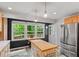 Kitchen featuring a center island, stainless steel appliances, and cabinets for storage at 4404 Oak Park Rd, Raleigh, NC 27612