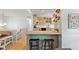 Cozy kitchen with wood cabinets, modern appliances, an island with seating, and hardwood floors at 4404 Oak Park Rd, Raleigh, NC 27612