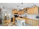 Open kitchen features wood cabinets, modern appliances, a center island, and elegant countertops at 4404 Oak Park Rd, Raleigh, NC 27612