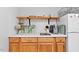 Kitchenette displays open wood shelving, granite counters, and a white refrigerator at 4404 Oak Park Rd, Raleigh, NC 27612