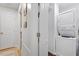 Bright laundry area features a stacked washer and dryer, offering convenience and space saving functionality at 4404 Oak Park Rd, Raleigh, NC 27612