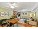A living room combines dining with a brick fireplace, integrated with modern furniture and decor at 4404 Oak Park Rd, Raleigh, NC 27612