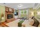 A cozy living area features a brick fireplace, large windows, and comfortable seating arrangement at 4404 Oak Park Rd, Raleigh, NC 27612