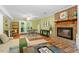 This large living area features a brick fireplace and dining area with views of the outside deck at 4404 Oak Park Rd, Raleigh, NC 27612