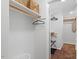 Walk-in closet with custom shelving, wood dowels and overhead storage baskets at 4404 Oak Park Rd, Raleigh, NC 27612
