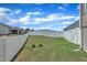 Well-maintained backyard with lush green grass and a white privacy fence at 48 Highview Ct, Fuquay Varina, NC 27526