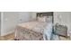 Comfortable bedroom featuring a decorative quilt, bedside tables with lamps, and natural light at 48 Highview Ct, Fuquay Varina, NC 27526