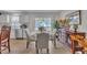 A dining area with a view of the exterior is decorated with a wooden buffet table at 48 Highview Ct, Fuquay Varina, NC 27526