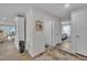 Hallway leads to bedroom with white doors, neutral walls, and wood floors, with dining area visible at 48 Highview Ct, Fuquay Varina, NC 27526