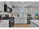 Modern kitchen with white cabinets, stainless steel appliances, and ample counter space at 48 Highview Ct, Fuquay Varina, NC 27526