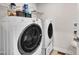 Well-equipped laundry room with modern washer, dryer, and storage options on shelves at 48 Highview Ct, Fuquay Varina, NC 27526