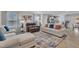 Open-concept living area with modern furniture, a decorative rug, and seamless kitchen access at 48 Highview Ct, Fuquay Varina, NC 27526