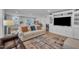 Spacious living area connecting to kitchen, showcasing a TV, décor, and natural light at 48 Highview Ct, Fuquay Varina, NC 27526