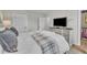 Spacious main bedroom featuring a large bed, dresser with television, and walk-in closet at 48 Highview Ct, Fuquay Varina, NC 27526